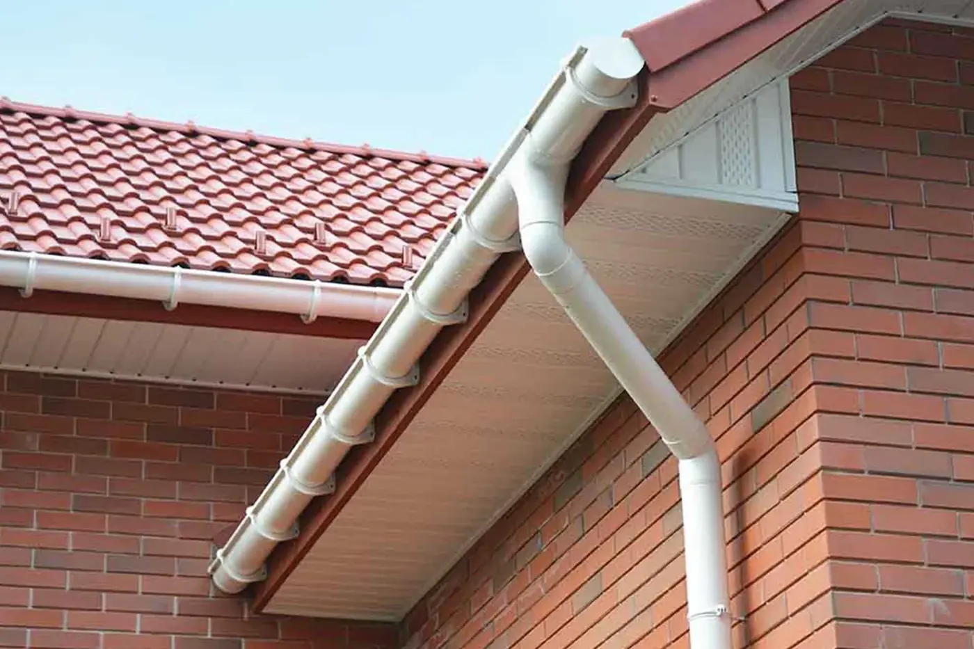 White fascias, soffits, guttering and downpipe on a brick house