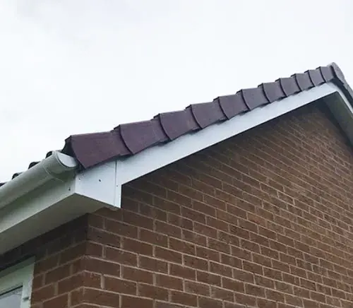White fascia board and soffit fitted beneath the roof edge